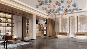 A spacious lobby with a modern design, featuring a large seating area, a vending machine, and a unique ceiling light fixture. - Fairfield By Marriott Changshu Hi-Tech Zone (Suzhou)
