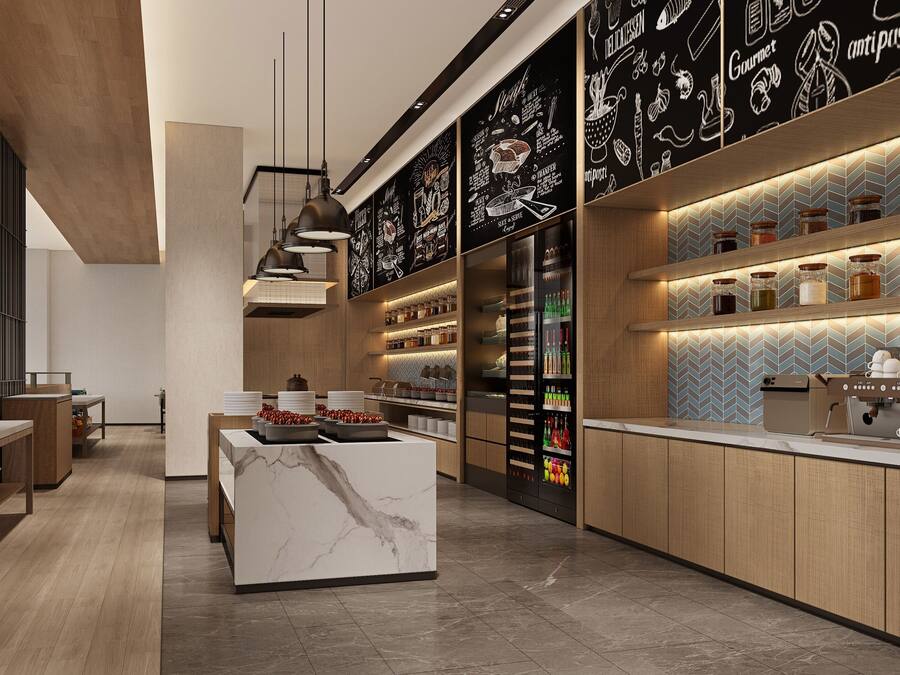 A modern kitchen with a marble island, pendant lighting, and a chalkboard wall with culinary illustrations.
