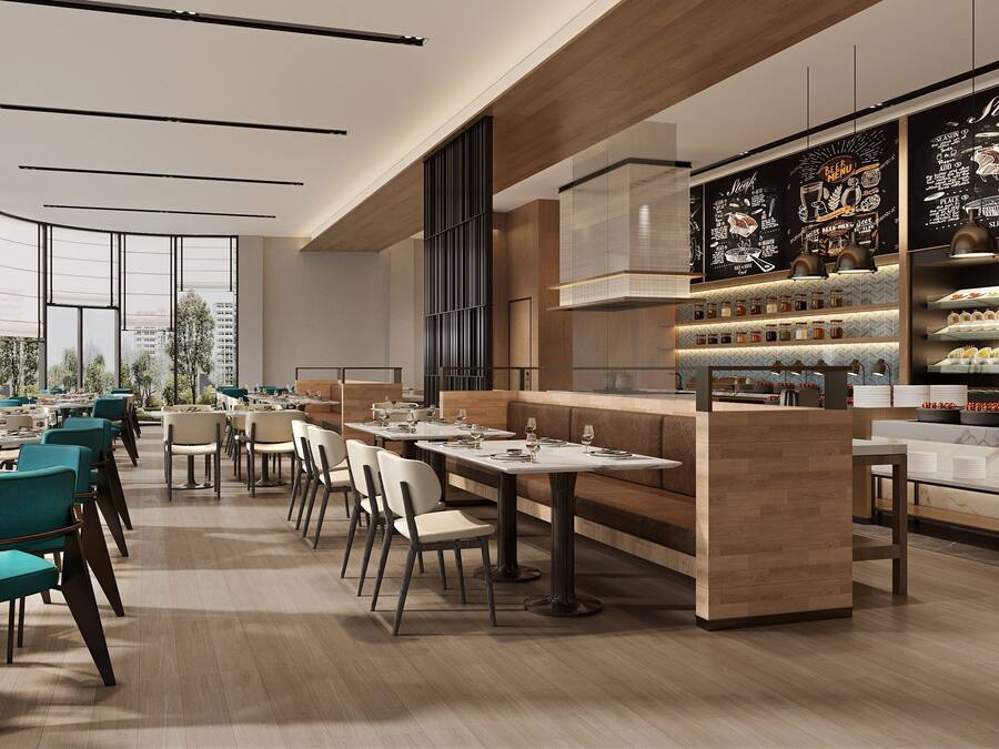 A modern restaurant with high ceilings, large windows, and a variety of seating options including tables and booths.
