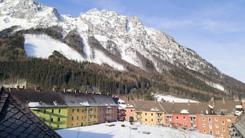 A snow-covered mountain with a residential area in the foreground.