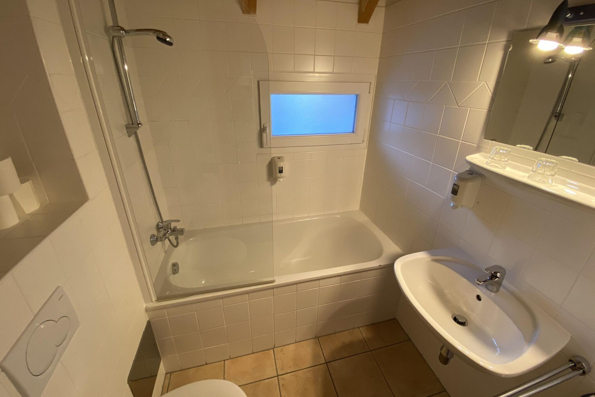 A bathroom with a bathtub, a sink, and a shower.