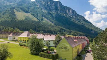 A resort with a mountain backdrop, featuring a prominent building labeled "Alpin Resort ERZBERG."