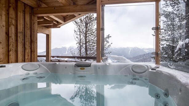 A hot tub with a wooden interior and large windows offering a mountain view. - Chalet near Ski Resort in Austria with Sauna (Turracherhöhe)