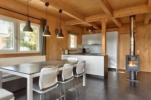 Enjoy cooking in this well-equipped kitchen with a central island, stove, and stainless steel range hood.