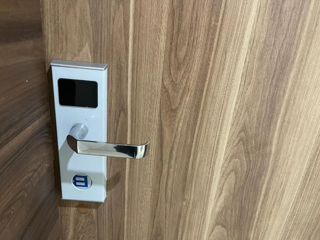 A modern door with a digital lock and a keyhole.