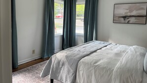A bedroom with a bed, a window with curtains, a rug, and a painting on the wall. - This house is a 2 bedroom(s), 1 bathrooms, located in Nashville, TN. (Nashville)