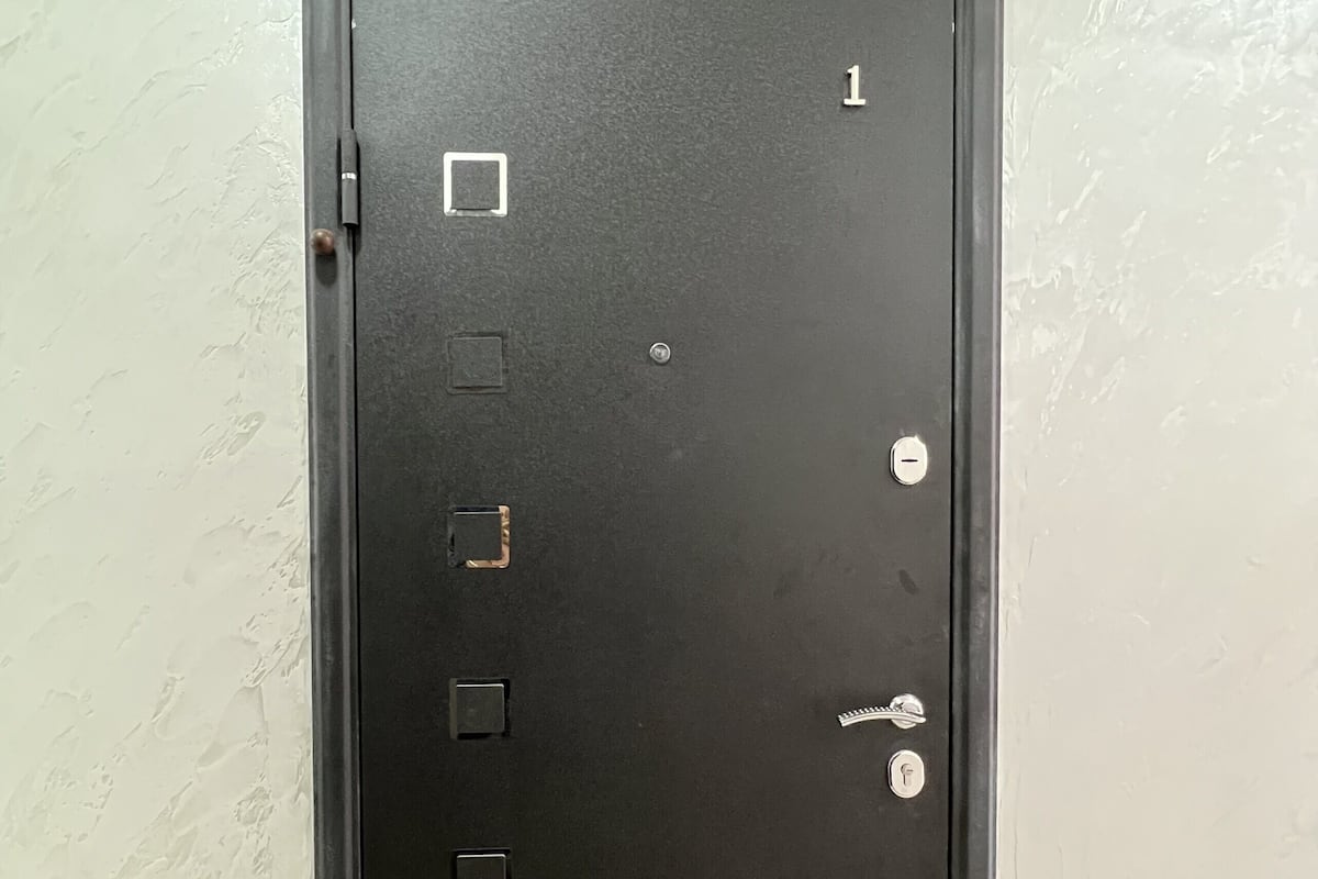 A black metal safe with a numeric keypad and a combination lock.