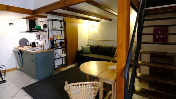 A compact kitchen with a dining area, a staircase, and a sofa. - Trevi Little Palace #9 (Roma)