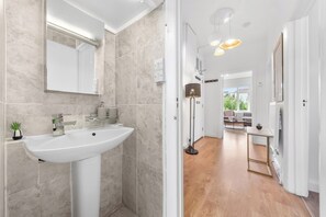 Combined shower/bathtub, deep-soaking bathtub, hair dryer, towels