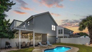 A two-story house with a covered patio, a swimming pool, and a fenced backyard. - 'A Shore Thing' - Pool - North Myrtle Beach! (North Myrtle Beach)