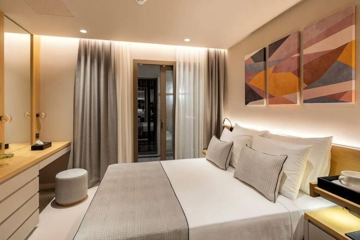 A bedroom with a bed, bedside table, and a wardrobe.