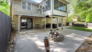 A two-story house with a covered patio and a fire pit. - Fox Creek Hideaway | Marcel Stays (Belleville)