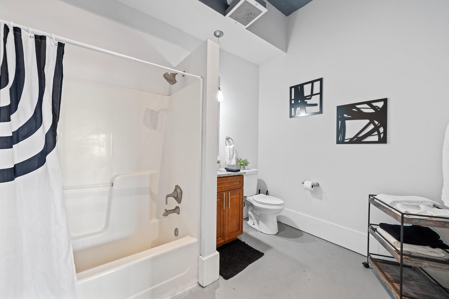 A modern bathroom with a walk-in shower, a toilet, and a sink.