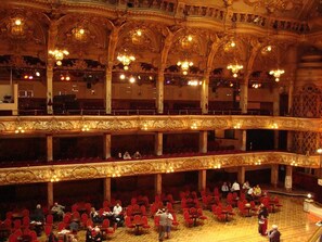A grand, ornate theater with multiple balconies and rows of red chairs. - Beacon View Lodge in Lancashire (Preston)