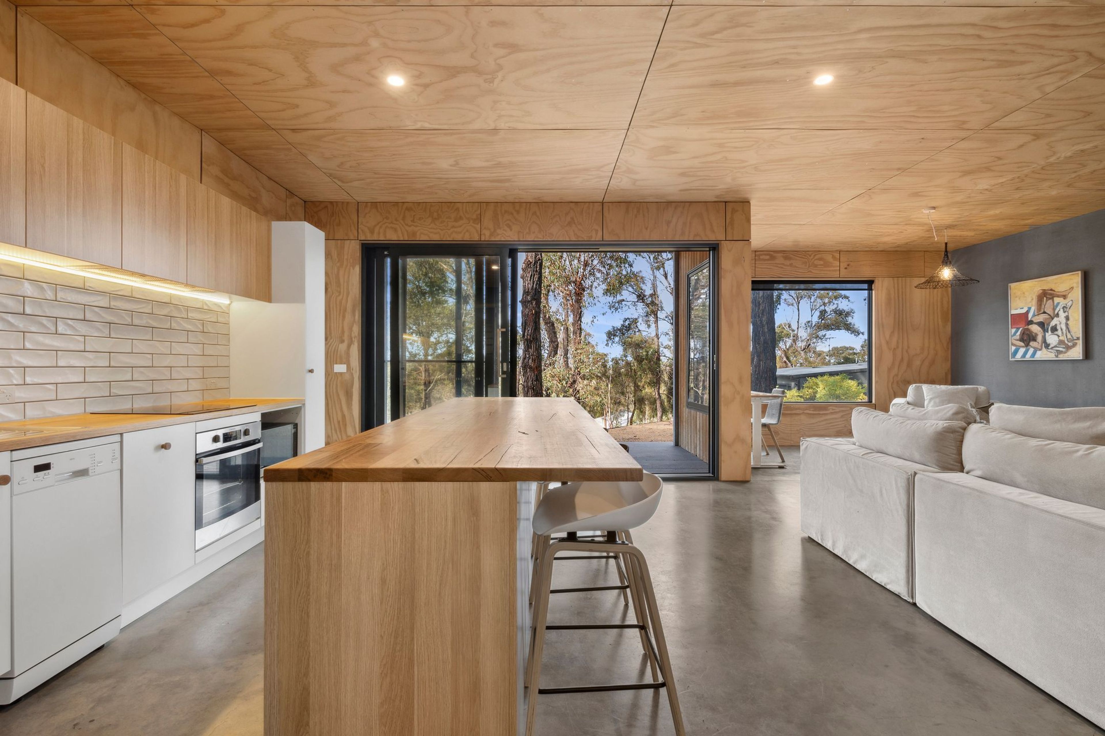 A modern kitchen with a wooden countertop and integrated appliances.