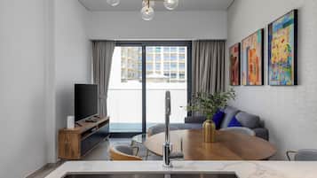 Deluxe Apartment, Balcony, City View | Living area | Flat-screen TV