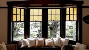 A corner seating area with a view through a bay window with multiple panes. - 'Buckley's Rest' on the doorstep of Battery Point (Battery Point)