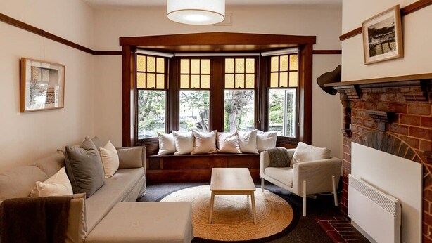 A cozy living room with a sofa, armchairs, a coffee table, and a fireplace. - 'Buckley's Rest' on the doorstep of Battery Point (Battery Point)