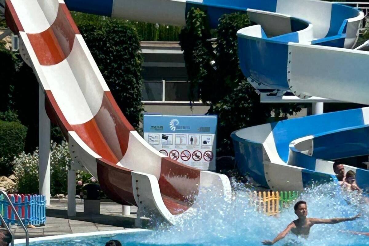 A water park with multiple water slides and a swimming pool.