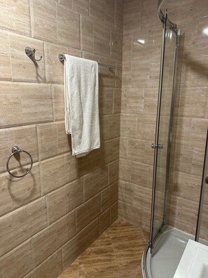 A shower with glass doors, a towel rack with a towel, and a toilet. - Private Apartments in Premier Fort Beach Sveti Vlas (Sveti Vlas)