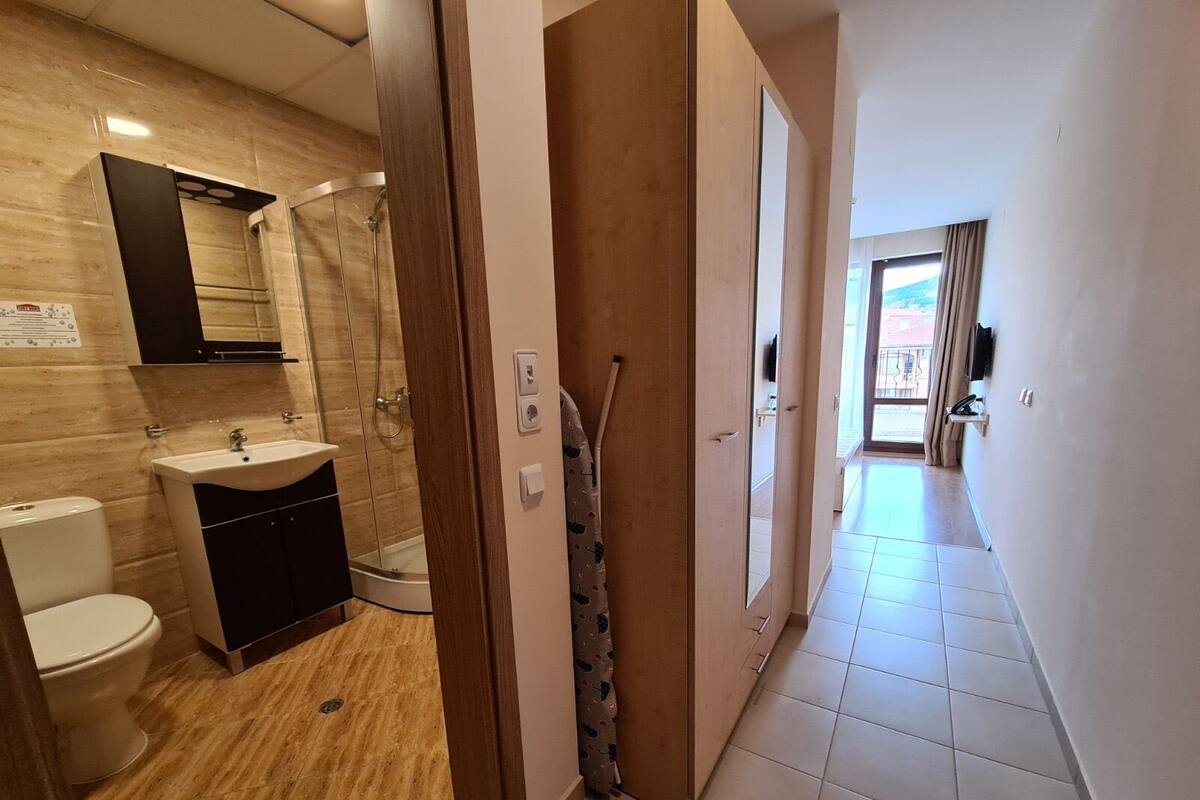 A bathroom with a toilet, sink, and shower.