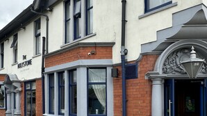 A building with a sign reading "The HOLYSTONE Bar & Restaurant" and a round table in the foreground. - Holystone Bar and Restaurant  (Newcastle-upon-Tyne)