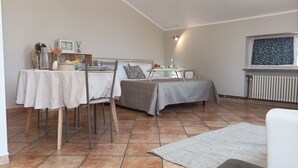 Une pièce confortable avec un lit, une table à manger et une fenêtre donnant sur un beau paysage.