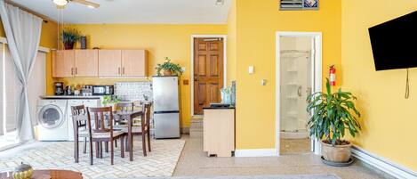 Eine kleine Küche mit Holzausstattung, einem Kühlschrank und einem Deckenventilator.