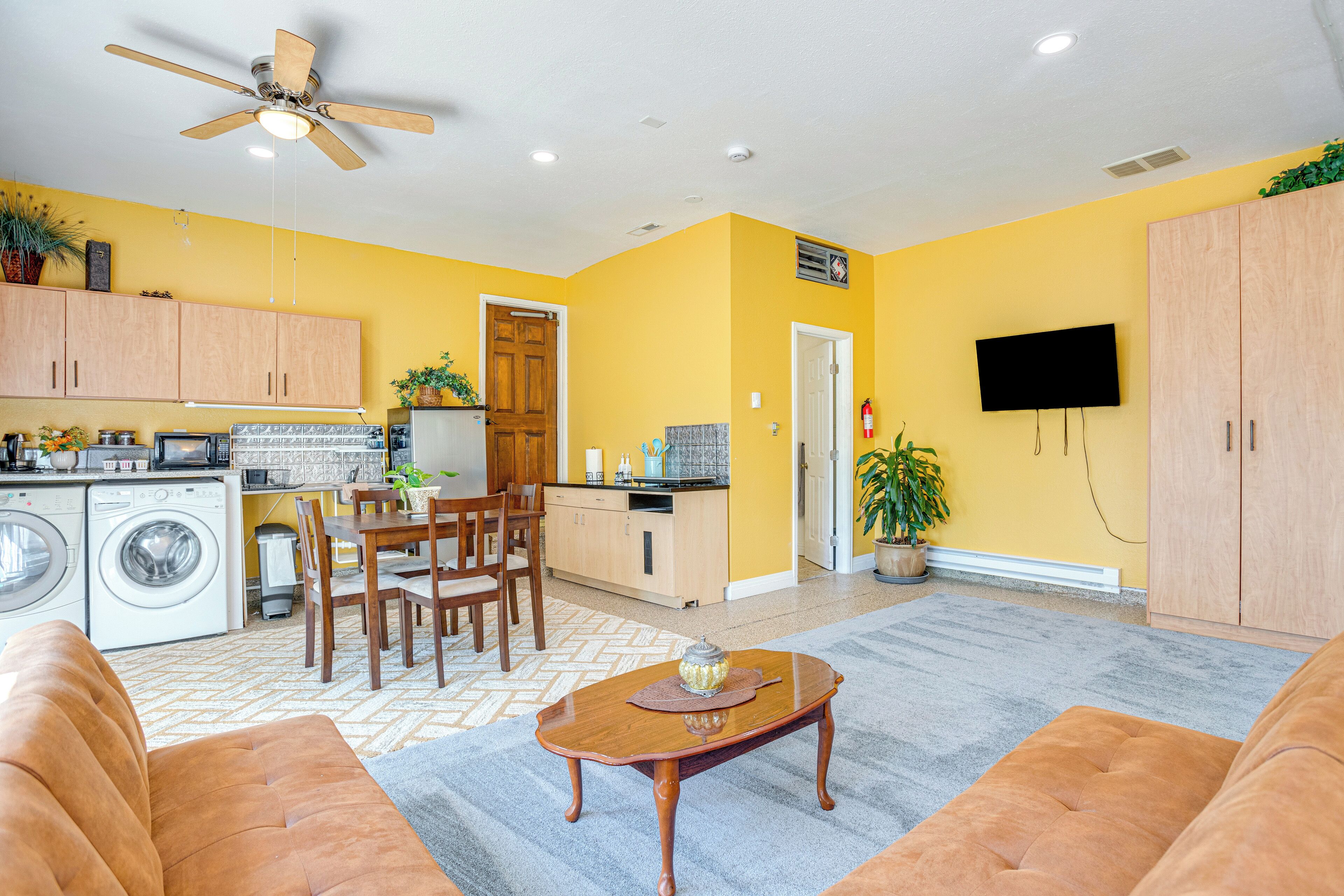 A compact living space with a kitchen, dining area, and seating area.
