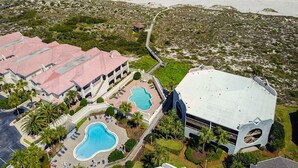 An aerial view of a resort with multiple buildings, a swimming pool, and a beach. - Seaside Haven Stylish Condo 3 Pools New Rental (St. Augustine)