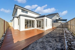 A modern two-story house with a wooden deck and a fenced backyard. - Modern Cozy Retreat, Park, Mall! (Berwick)