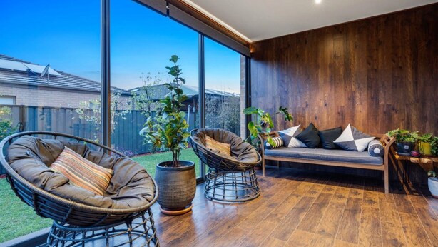 A modern patio with wicker chairs, a cushioned bench, and potted plants. - Modern Cozy Retreat, Park, Mall! (Berwick)