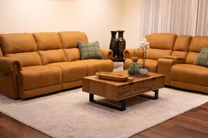 A living room with two sofas, a coffee table, and decorative items. - Modern Cozy Retreat, Park, Mall! (Berwick)