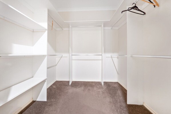 A walk-in closet with open shelves and a hanging rod. - Spacious 4BR Family Retreat | Theatre & Sunroom (Berwick)