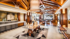 A spacious lobby with a high ceiling, wooden beams, a central table, and seating areas. - Luxury 4bdr Residence Steps From Heavenly Village 4 Bedroom Condo (South Lake Tahoe)