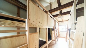 A wooden interior with bunk beds and a ladder. - Fukuoka Guesthouse CAMP (Fukuoka)
