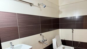 A bathroom with a sink, toilet, and shower. - Bommarillu Residency (Hyderabad)