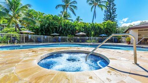 A swimming pool with a hot tub, surrounded by palm trees and lounge chairs. - Blissful 1 Bedroom w/lanai, WiFi, and Cable-#H206 (Kihei)