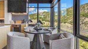 A modern kitchen with a large window overlooking a scenic landscape. - One Snowmass West 601 (Snowmass)