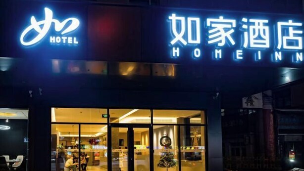 A hotel entrance with a neon sign, glass doors, and a reception area visible inside. - Homeinn · neo (Changzhi Medical College) (Changzhi)