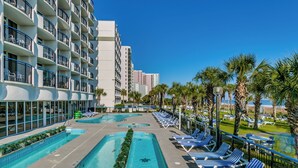 Ein Hotelpoolbereich mit mehreren Schwimmbecken, Liegestühlen und Palmen.
