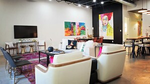 A modern living room with a sofa set, a dining area, and artwork on the walls. - Frida's House - Historic Downtown  (San Angelo)