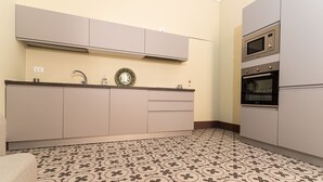 A kitchen with a patterned floor, cabinets, a microwave, and an oven. - Capo10 Liberty C1 in Syracuse (Syracuse)