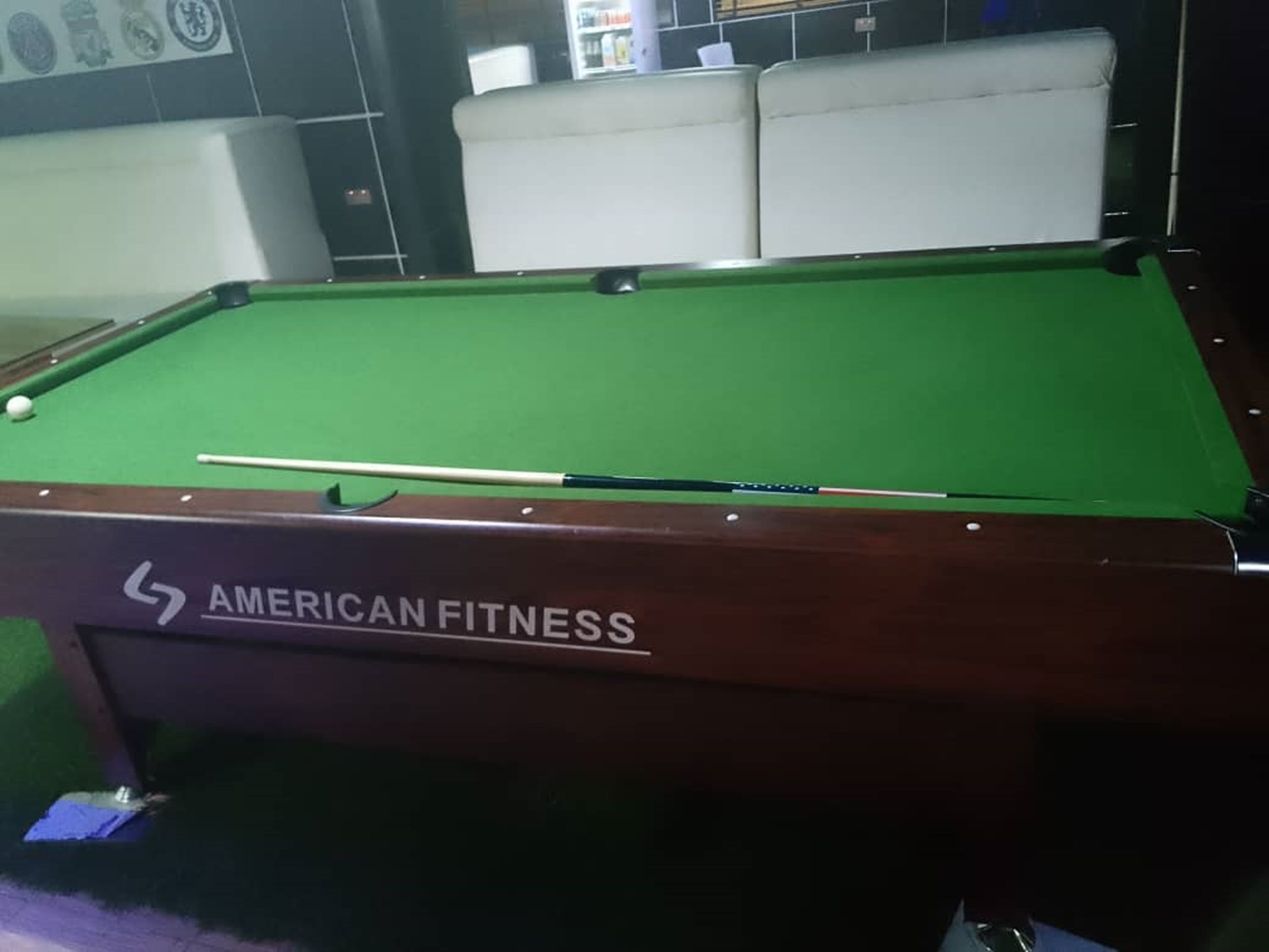 A pool table with a cue stick on it.