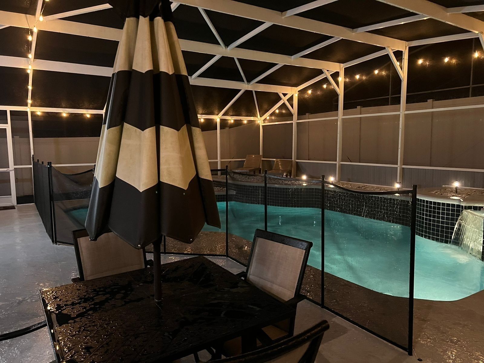 An indoor pool area with a seating arrangement and a ceiling structure.
