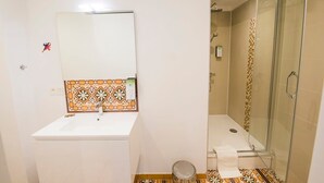 A bathroom with a sink, mirror, shower, and patterned tiles. - Harry Potter self check-in studio / Nespresso / Ne (Saint-Gilles)