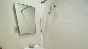 A bathroom with a toilet, sink, and bathtub. - Relaxing Getaway in our Homespun Double Kitchenette at Lodges of Oak Creek! (Oak Creek)
