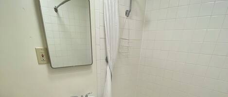 A bathroom with a toilet, sink, and bathtub.