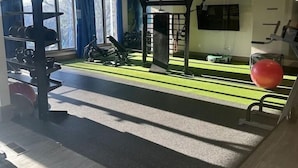 A gym with exercise equipment, a pull-up bar, and a large red exercise ball. - King Suite | 1mi to The Battery + Mins to Midtown! (Atlanta)