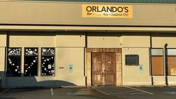 A building with a sign reading 'ORLANDO'S Bar + Southern BBQ'.